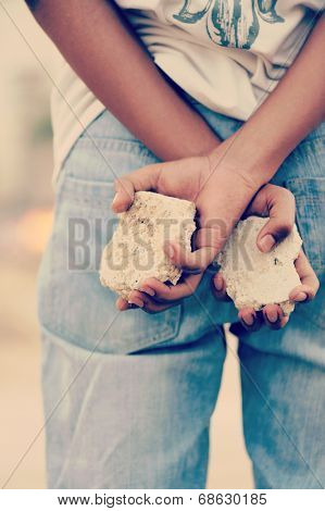 Palestinian Intifada boy with rocks in hands ready for fight