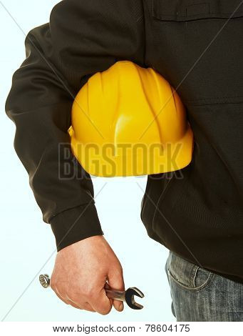 Yellow Hard Hat And Spanner In Hand Working Man