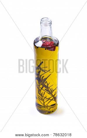 Bottle of olive oil with rosemary and pepper isolated on white background