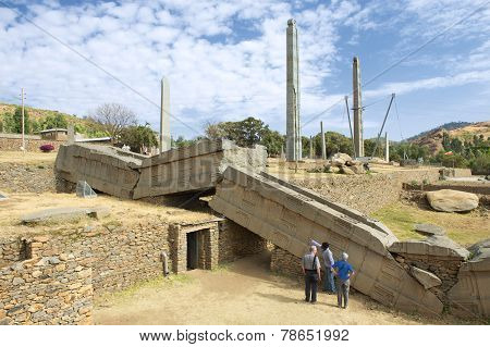 Tourists explore famous collapsed obelisks of Axum, Ethiopia.