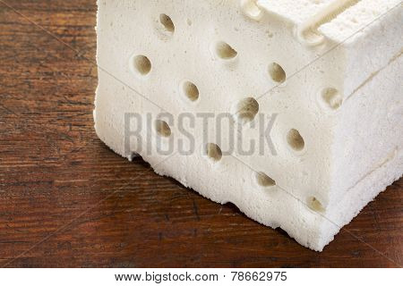 a sample of natural latex used in organic mattresses over grunge wood background