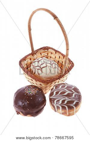 traditional jewish holiday chanuka donuts covered by dark and white chocolate pattern on retro vintage basket isolated on white background