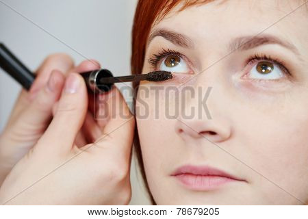 Makeup technique. mascara eyelashes of redheaded woman ?? beauty salon