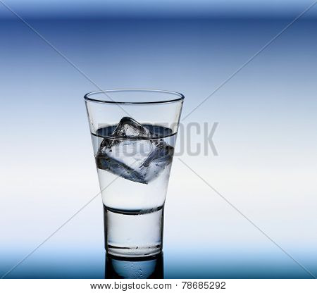 Short Drink Glass With Clear Liquid And Ice Cubes