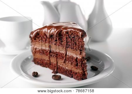 Delicious chocolate cake on plate on table on light background
