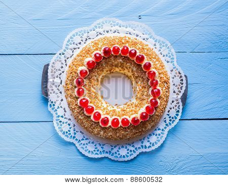 Frankfurt Crown Cake With Cherries On A Blue Wood