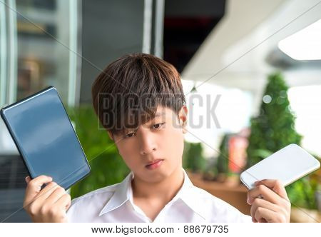 Asian Male Decide And Hesitate To Use  Smart Device