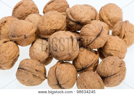 ripe walnuts heap isolated on white background