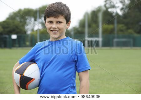 Portrait Of Boy Holding Ball On School Rugby Pitch