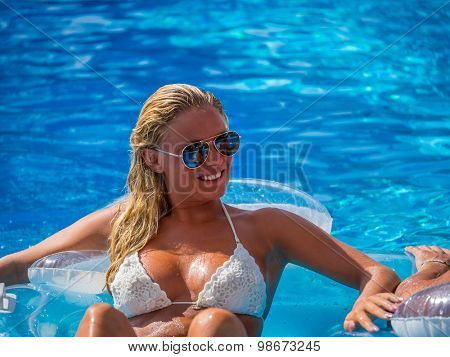 Couple Outside Relaxing In Swimming Pool in the summertime