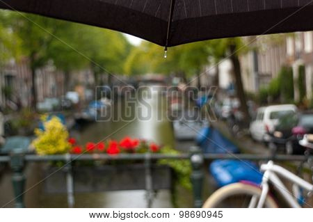 Rainy Amsterdam, blurred view above the umbrella