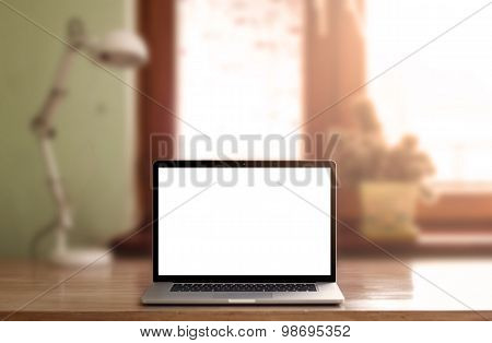 Notebook with blank screen on table.