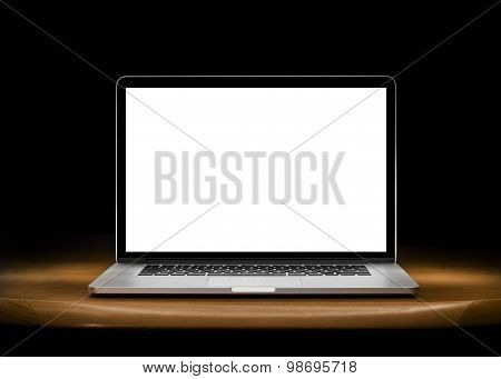 Notebook with blank screen on table.