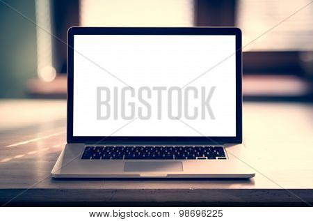 Notebook with blank screen on table.