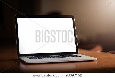 Notebook with blank screen on table.