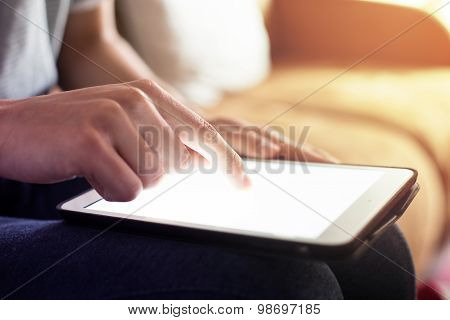 Person using the digital tablet in living room