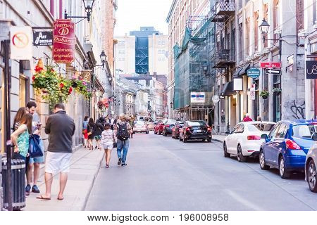 Montreal, Canada - May 27, 2017: Old Town Area With People Walking Up Street And Cars Driving In Eve