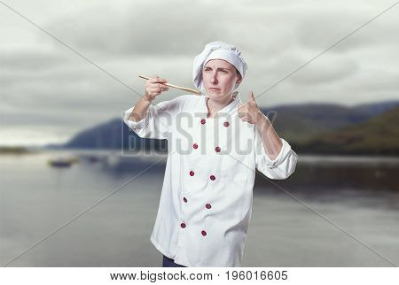 Young Woman Chef Is Making A Traste Food Gesture