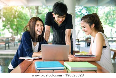 Young Students Group Consult with School FoldersLaptop Computer in Education Campus University