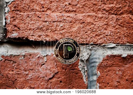 Gold Peercoin On The Wall