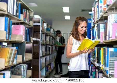 Young Student Girl Reading Book in Classroom Education Library