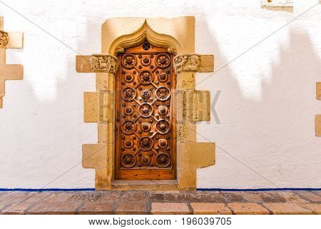 The wooden door of the museum Marisel de Mar Sitges Barcelona Catalunya Spain.