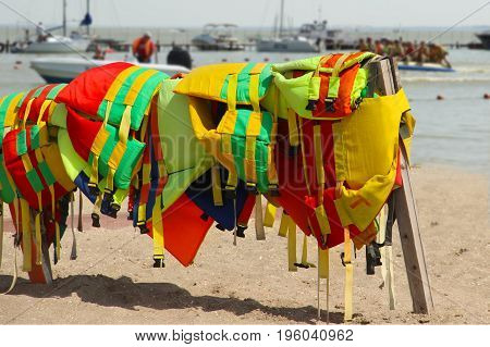 Colorful Life Jackets Save Your Life. Safety In Water. Rescue Service On The Beach. Injuries To Wate