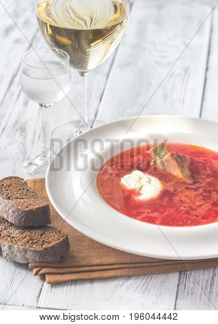 Borsch - Ukrainian traditional beetroot soup on the wooden table