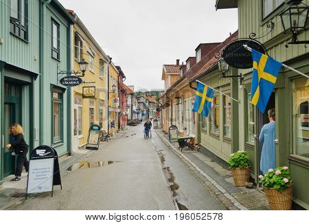 Sigtuna, Sweden-July 10, 2017:Sigtuna, Sweden, shopkeepers on the old main street (Stora Gatan) preparing to open their shops early in the morning
