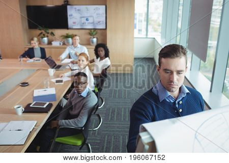 Serious business entrepreneur explaining strategy to team in meeting room at office