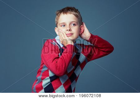 boy listening to something, isolated against grey background