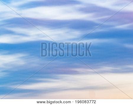 Watercolor effect of a cloudy sky with blue, lavender and yellow tinta