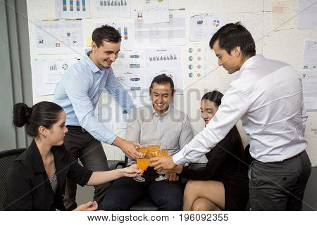 Businessman Holing Glass For Drinking With Business Discussion Concept And A Group Of Person 30-40 Y