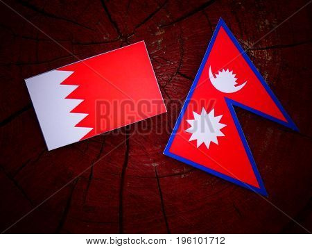 Bahraini Flag With Nepali Flag On A Tree Stump Isolated