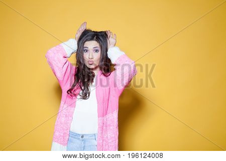 bright girl shows hands ears 1 2