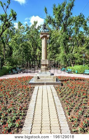Central park with statue of Alexander Puskin, Chisinau, Moldova, sunny day blue sky trees and flowers