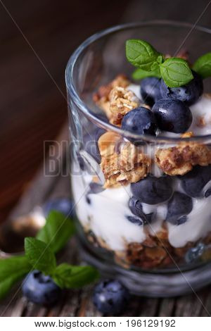 Glass With Granola Muesli Joghurt And Blueberries