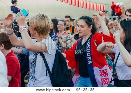 Moscow Russia - April 24 2016: People dancing around the stage of the Yagura the dance of Bon Odori at the japanese festival.