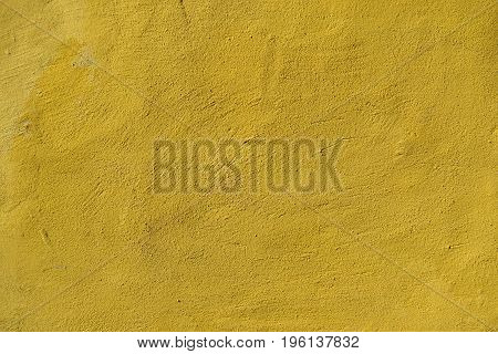 yellow concrete background with scraps to be used as texture