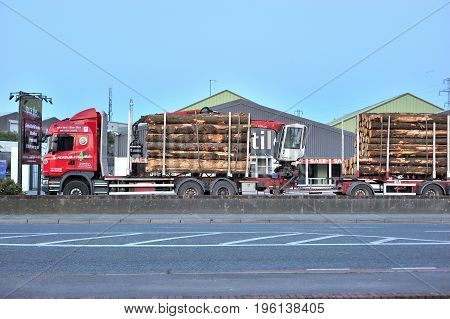 Red Truck with Trailer and Crane Loaded With Wood Tuam Road Galway Ireland Jul 2017