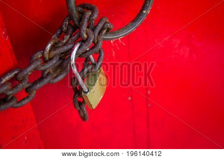 Old lock pad locked on the red door.