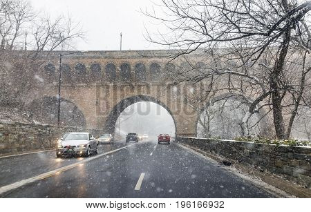 Washington Dc, Usa - January 7, 2017: Winter Snow Storm On Road With Cars And Dumbarton Bridge With