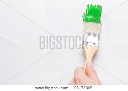 Construction Brush In Hand On White Background. Not Isolated
