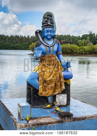 Grand Bassin Mauritius - December 26 2017: The Shiva statue at Ganga Talao (Grand Bassin) Hindu temple Mauritius. It's a copy of the Shiva statue of Sursagar Lake in Vadodara Gujarat India.