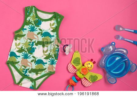 Baby clothes and accessories on pink background. Top view. Copy space. Still life. Flat lay