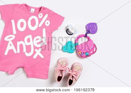 Baby clothes and accessories on white background. Top view. Copy space. Still life. Flat lay