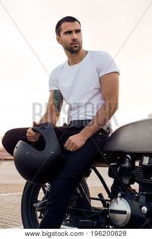 Brutal Man Sit On Cafe Racer Custom Motorbike.