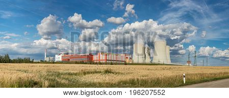 Panoramatic view on Nuclear power plant Temelin in the Czech Republic. Operating buildings and control rooms. Clouds of steam derailing from a nuclear power station tower.