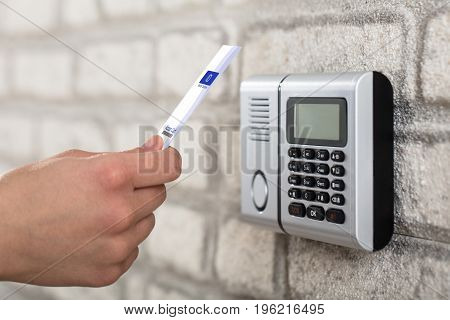 A Person's Hand Holding Access Card To Lock And Unlock Door