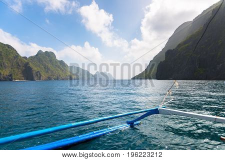 From the boat sharp rocks with tropical vegetation in El Nido's bay during summer time. Beautiful scenic landscape in Palawan Philippines.